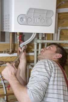 Plumber repairing boiler